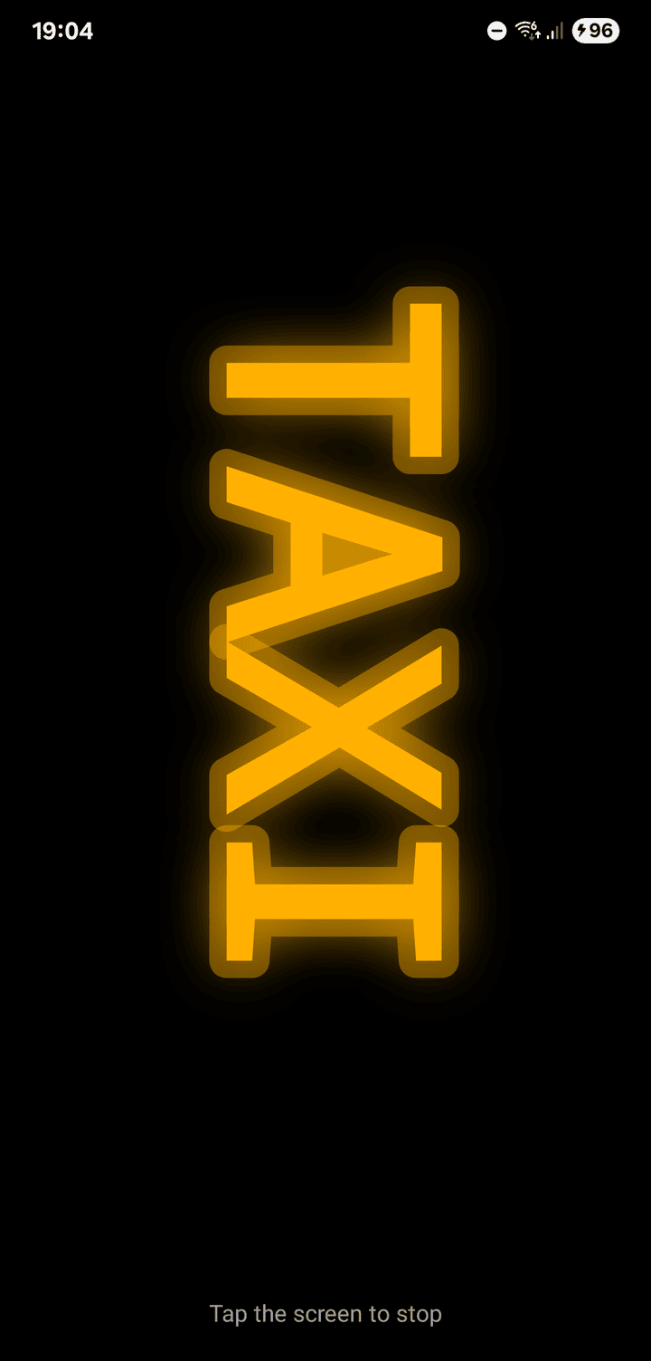 An amber neon sign reading TAXI, turned on its side
